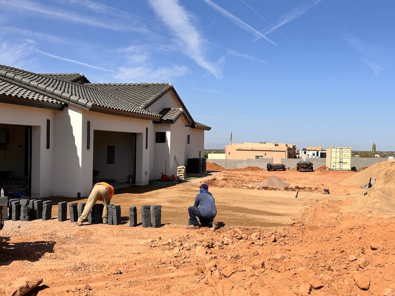 Crew preparing base for paver patio installation in Mesa, AZ