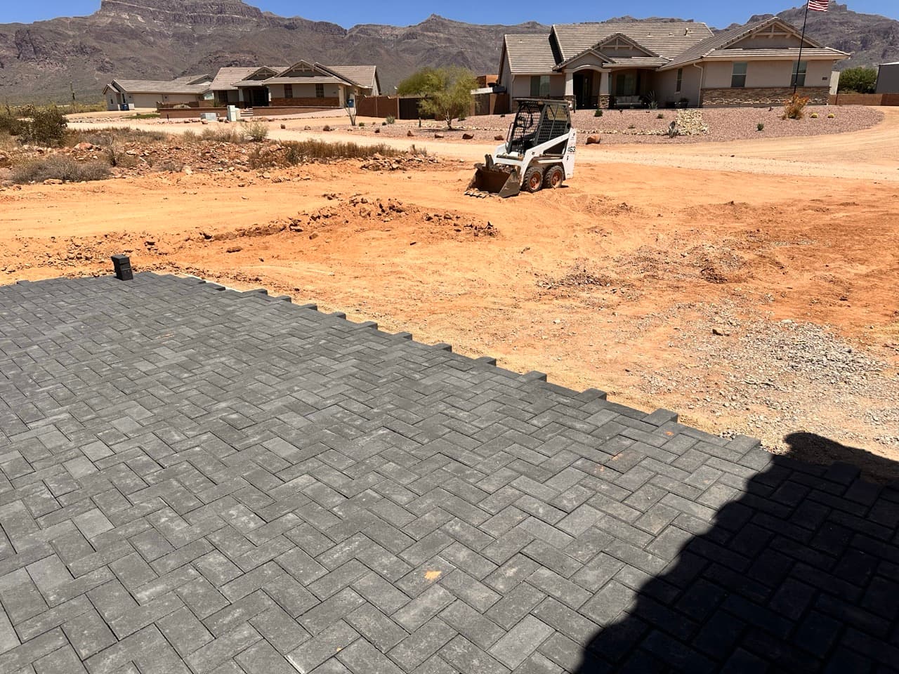 Large paver installation in progress with equipment on site in Mesa, AZ